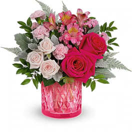 Pink and white rose bouquet in a pink glass vase