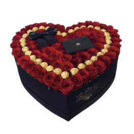 Heart-shaped box filled with red roses and gold chocolates