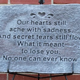 Stone memorial plaque with a sympathy poem on a stand