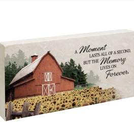 Decorative memorial plaque with a barn, sunflowers, and a remembrance quote