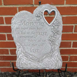 Heart-shaped memorial plaque with floral decoration and engraved text