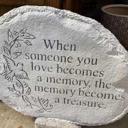 Engraved memorial stone with a dove and floral vine design