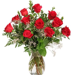 Red roses arranged in a clear glass vase