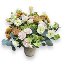 Mixed bouquet in a gray vase with pale pink and white blooms