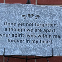 Memorial plaque with a heart cutout and engraved remembrance message