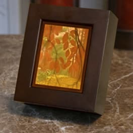 Decorative framed tabletop piece with orange leaf design