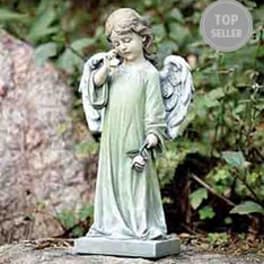 Garden angel statue in a pale green robe holding a small flower