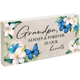 Memorial plaque with flowers and blue butterflies reading "Grandpa, always & forever in our hearts."