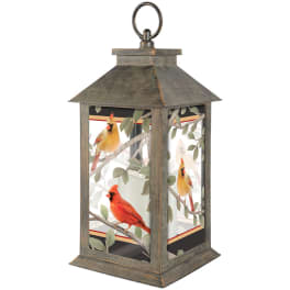 Decorative metal lantern with cardinal bird artwork