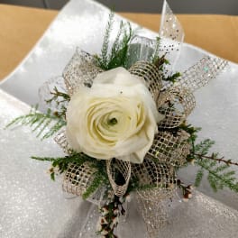 White rose boutonniere with silver ribbon and greenery