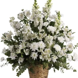 White mixed flowers arranged in a woven basket