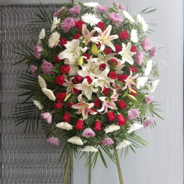 Large standing floral spray with red roses and white lilies