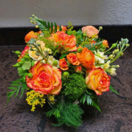 Bouquet of orange and yellow roses with green filler
