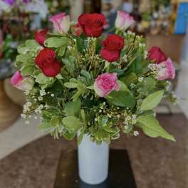 Bouquet of red and pink roses in a white vase