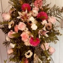 Tall pink and white floral standing spray on an easel