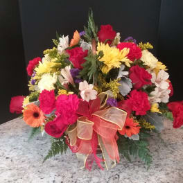 Mixed bouquet of roses, carnations, and daisies with a ribbon