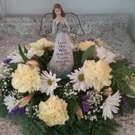 Floral wreath with a figurine centerpiece on a countertop
