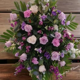 Large bouquet of pink, lavender, and white roses with purple flowers
