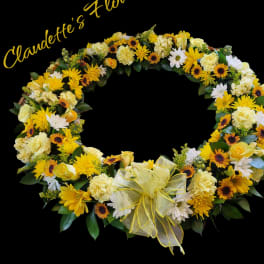 Yellow and white floral wreath with a ribbon bow