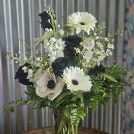Black and white flower bouquet in a clear glass vase