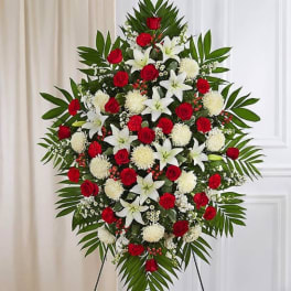 Standing floral spray with red roses, white lilies, and white mums