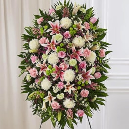 Large standing floral spray with pink and white flowers on an easel