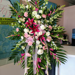 Large standing floral spray with pink and white flowers on an easel