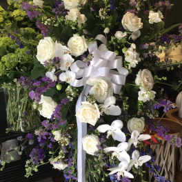 Large standing floral spray with white roses and purple flowers