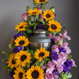 Sunflower and pink rose funeral urn arrangement