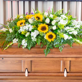 Sunflower and white floral casket spray with greenery