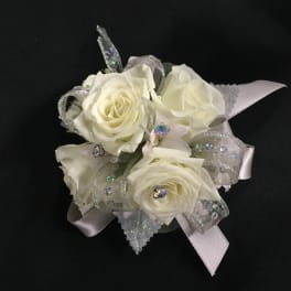 White rose corsage with silver ribbon and rhinestone accents