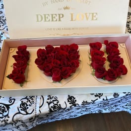 Red roses arranged in a gift box to spell "I LOVE U"
