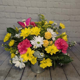 Yellow and white daisy bouquet with pink carnations in a metal bucket