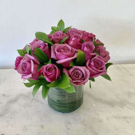 Pink roses arranged in a clear glass vase