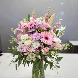Pink and white mixed bouquet in a clear glass vase