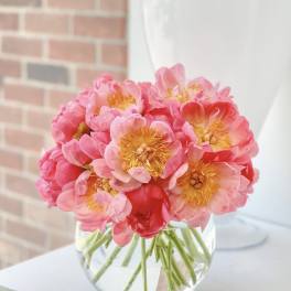 Pink peony bouquet in a clear glass vase