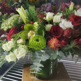 Mixed bouquet of red and white roses with green chrysanthemums in a vase