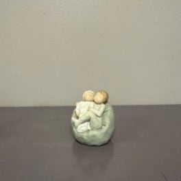 Small decorative figurine of two figures embracing