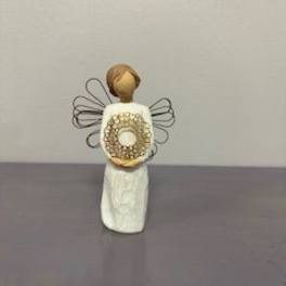 Small angel figurine with wire wings and a white dress