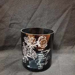 Black memorial candle holder with white floral line art and text