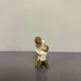 Small figurine of an adult holding a child