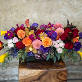Colorful mixed flower arrangement in a low rectangular container