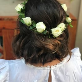 White rose flower crown on a woman's dark hair