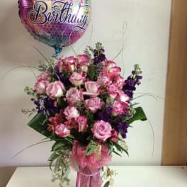 Pink and purple rose bouquet with a Happy Birthday balloon