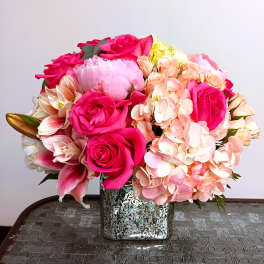 Pink roses and peach hydrangeas in a square silver vase
