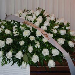 Large white rose funeral spray with a memorial ribbon