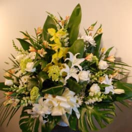 Large white and yellow floral arrangement in a vase