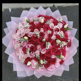 Large bouquet of pink and red roses with butterfly decorations