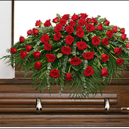 Red rose casket spray on a wooden casket