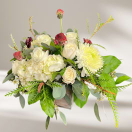 White roses and hydrangeas with yellow chrysanthemum in a wooden box